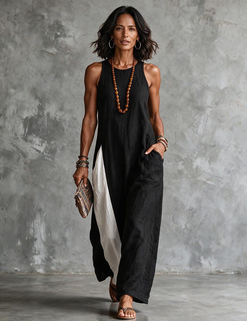 Black asymmetric sleeveless maxi dress with side slit and white panel detail