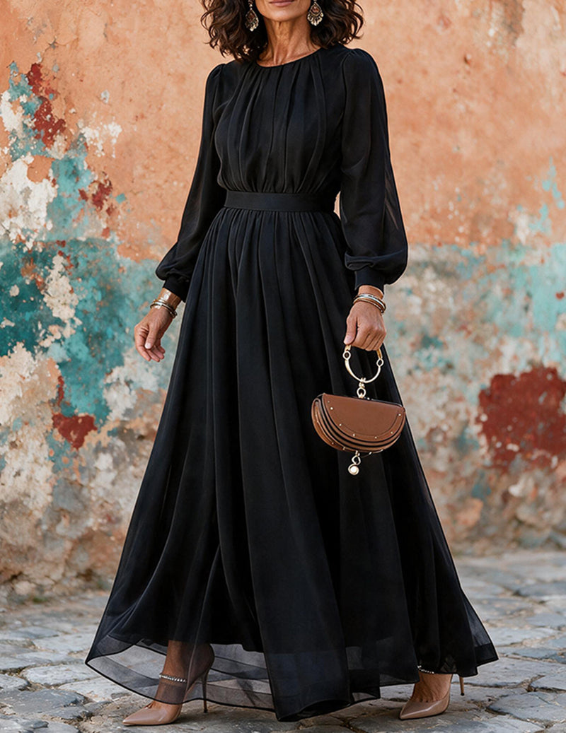 Black chiffon pleated maxi dress with long sleeves and gathered waist, full skirt.