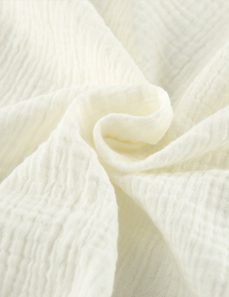 Close-up of white textured cotton fabric, soft crinkle weave