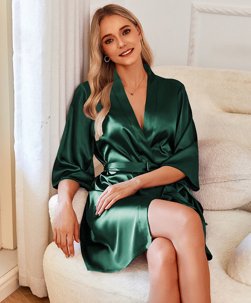 Satin robe in dark green, V-neck with tie belt, 3/4 sleeves, seated pose