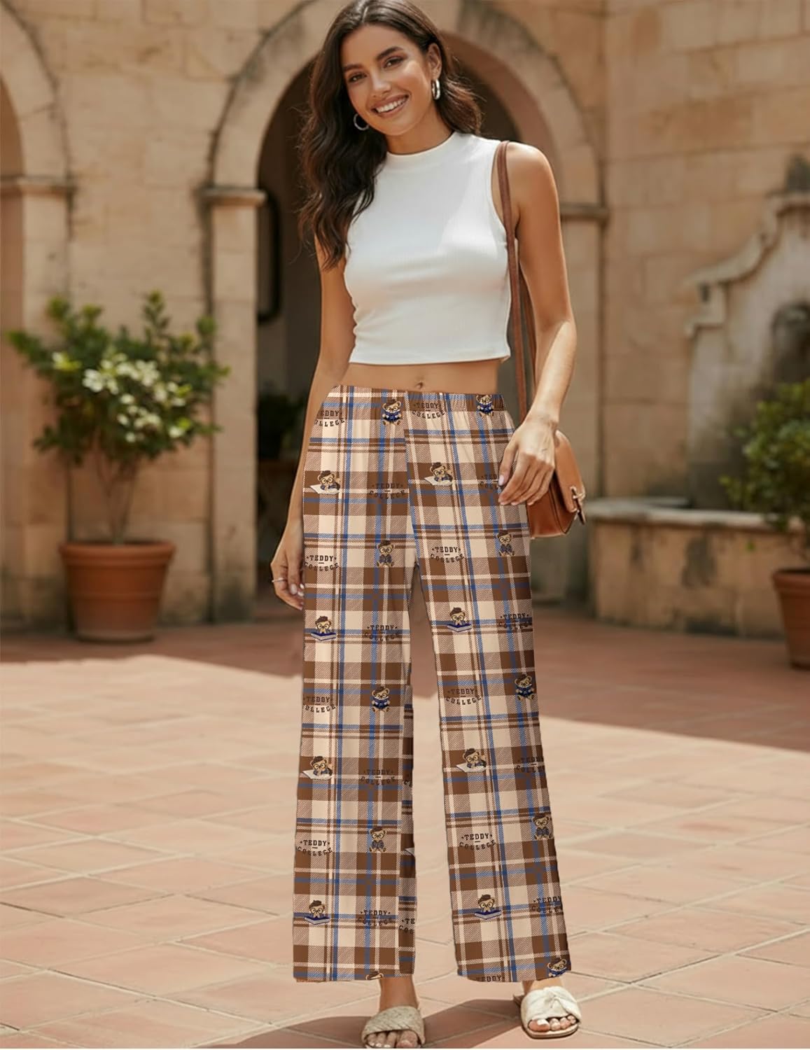 Wide-leg pajama pants in tan and navy plaid with small motif accents.