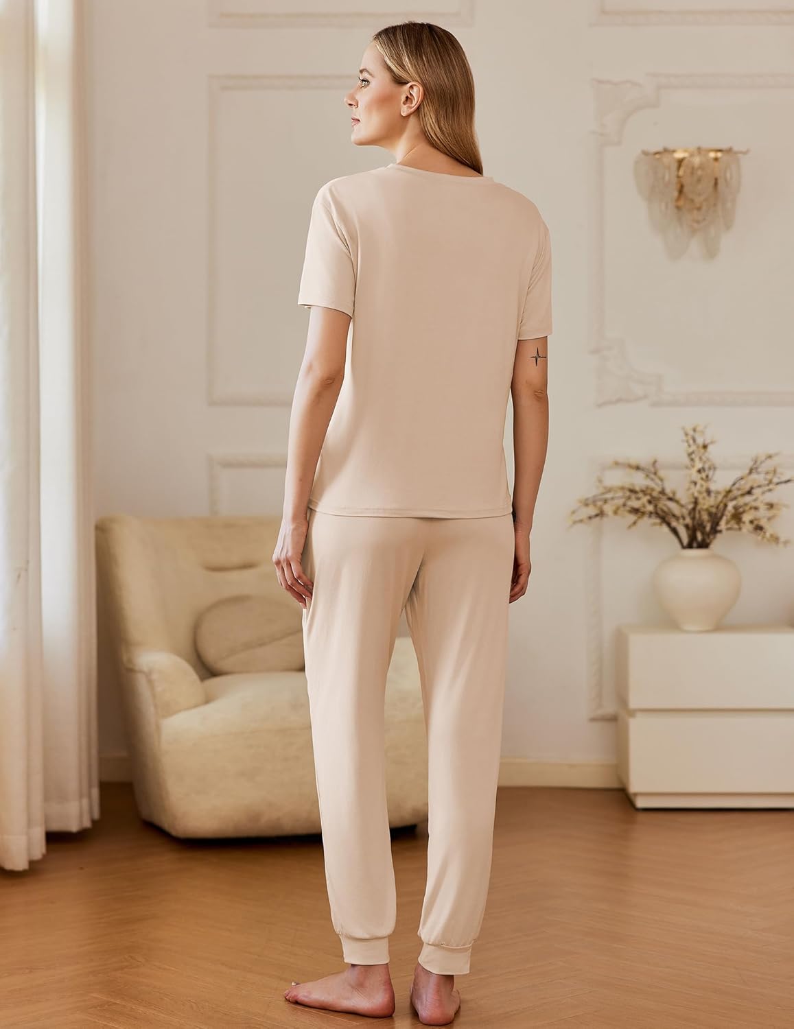 Back view: beige short-sleeve pajama top and matching cuffed pants, two-piece set