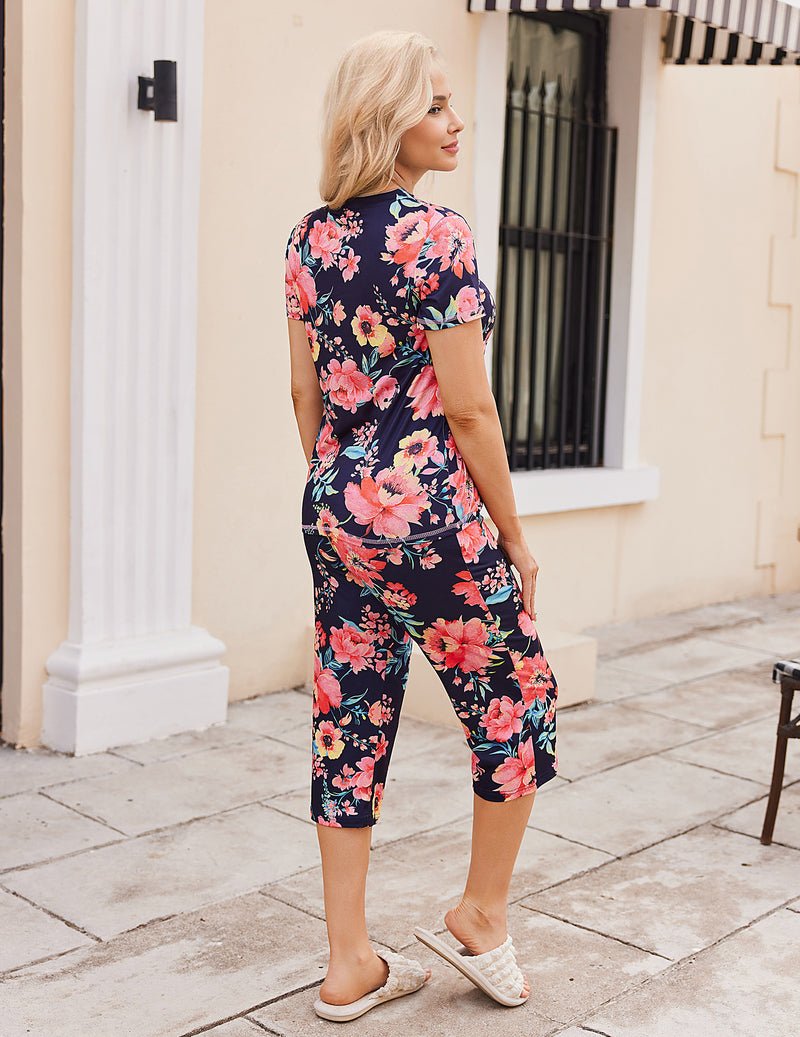 Floral pajama set with short-sleeve top and capri pants, dark base with pink blooms