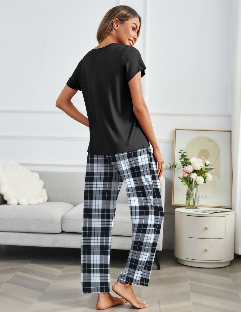 Black short-sleeve pajama top with black-and-white plaid long lounge pants (back view)