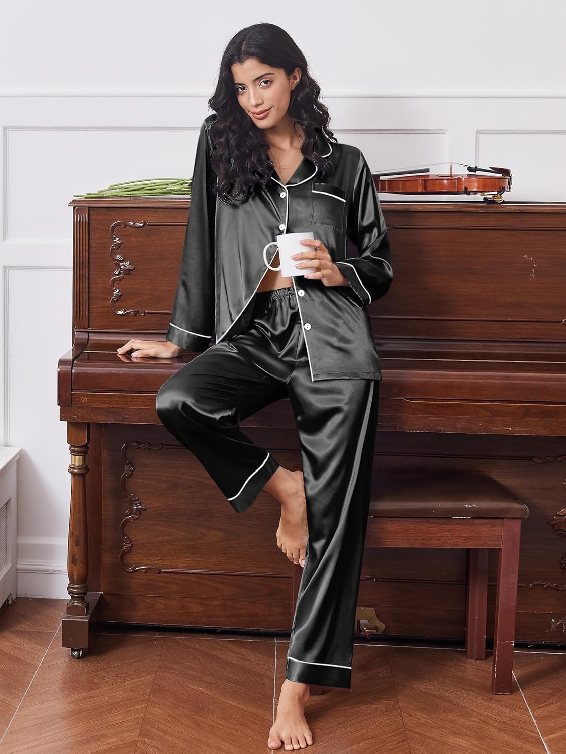 Black satin button-front pajama set with white trim and matching long pants