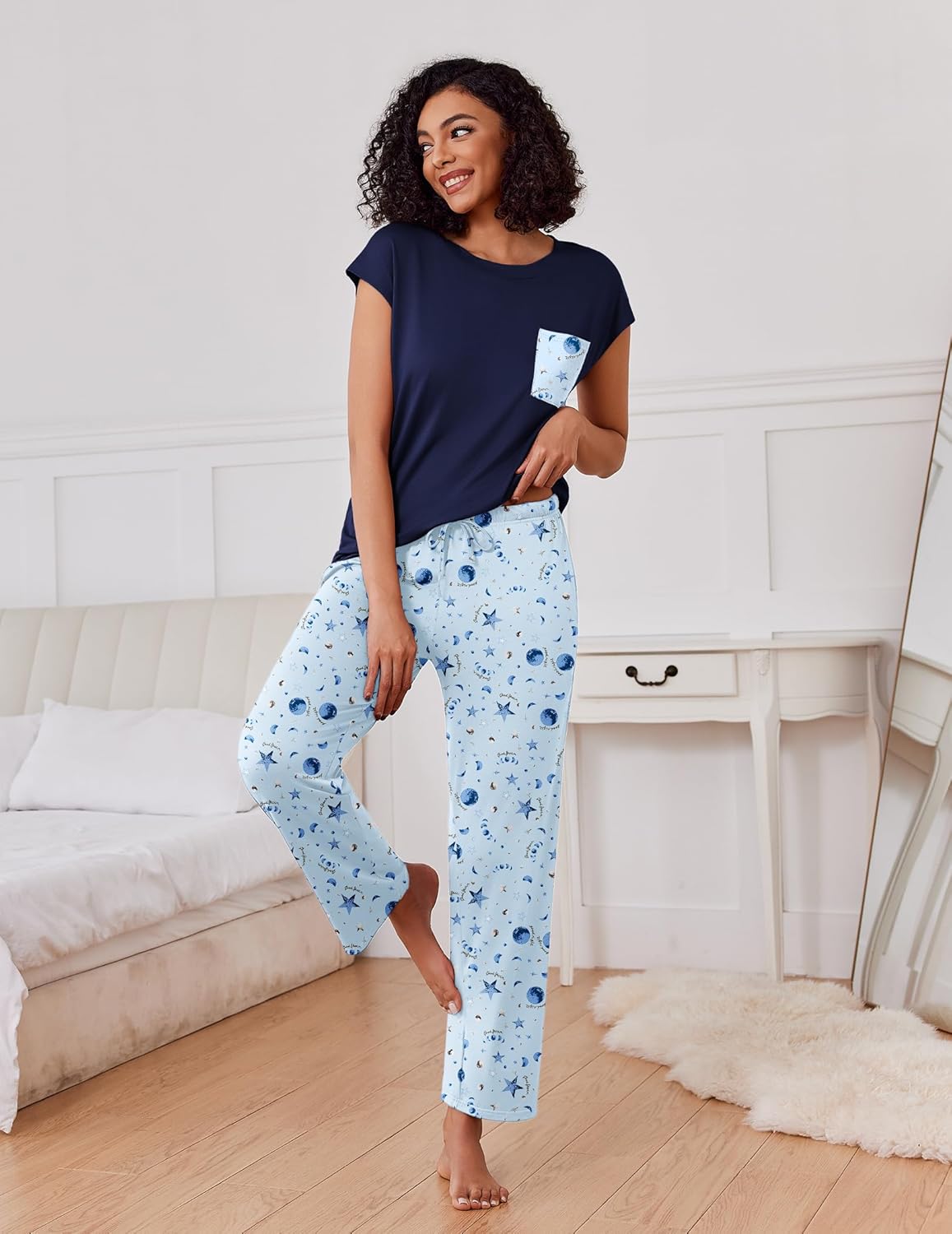 2-pack pajama set, back view: navy top with pocket and light blue star-print pants