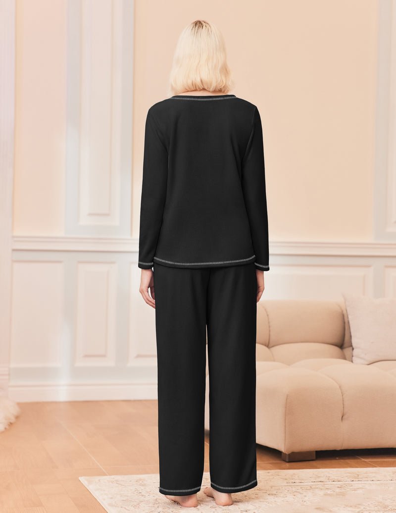 Black 2-piece lounge set: long-sleeve top with matching wide-leg pants, contrast piping