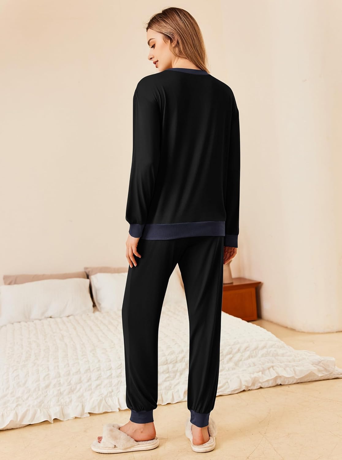 Back view: black long-sleeve pajama top with tapered matching jogger pants