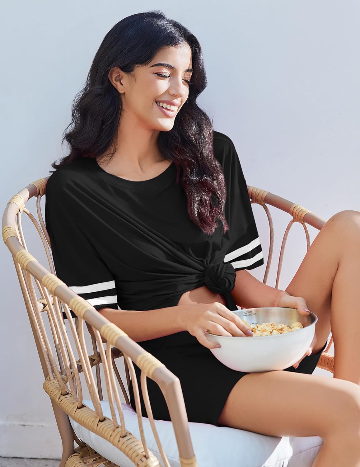 Black lounge set with round neck top and striped sleeve cuffs, paired with shorts