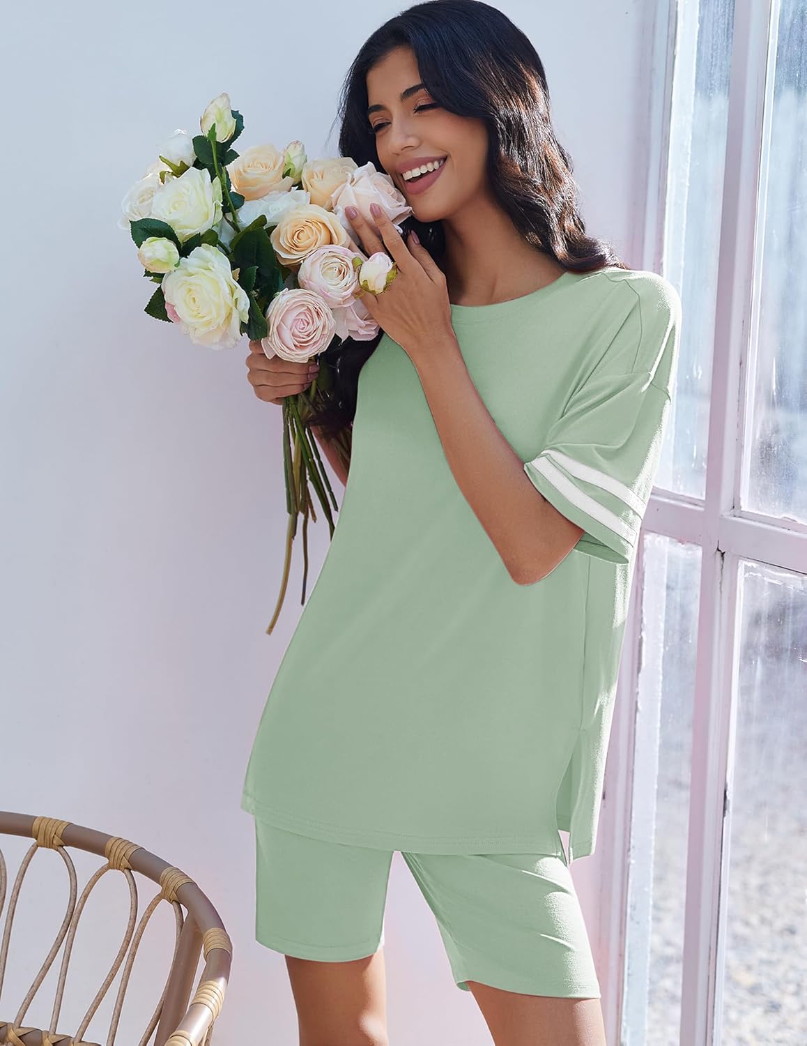 Two-piece lounge set with oversized light green top and matching shorts, striped sleeve cuffs.