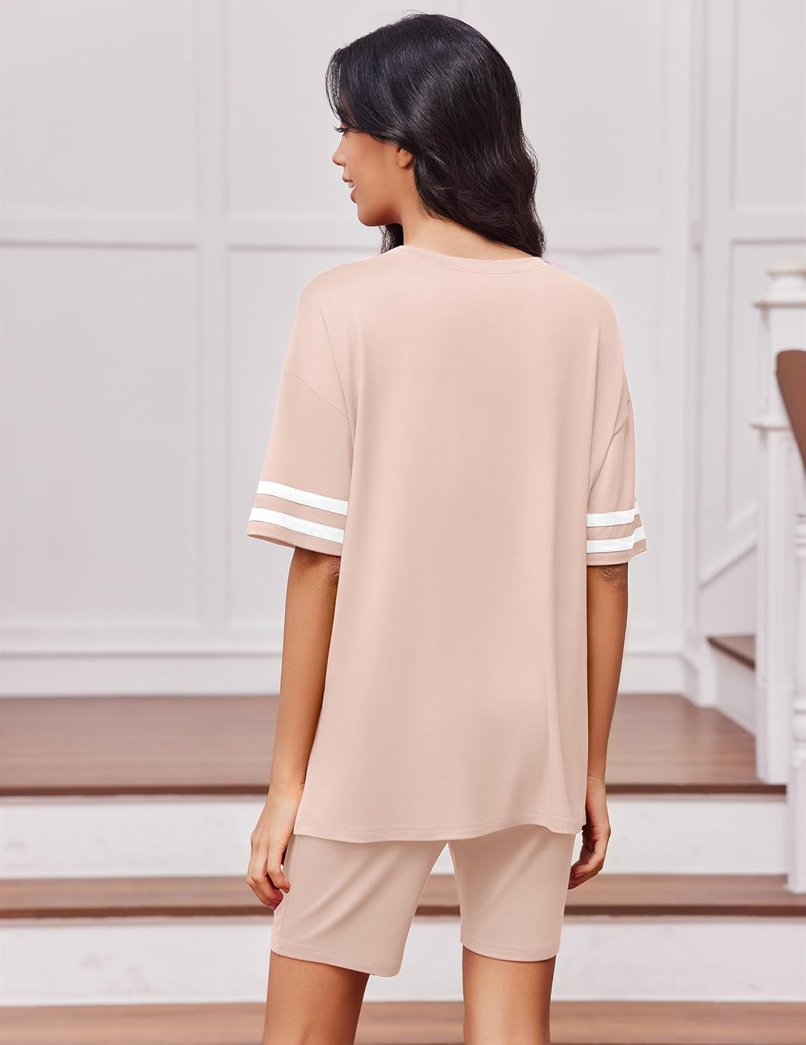 Two-piece lounge set in beige with oversized top and matching shorts, striped sleeve cuffs.