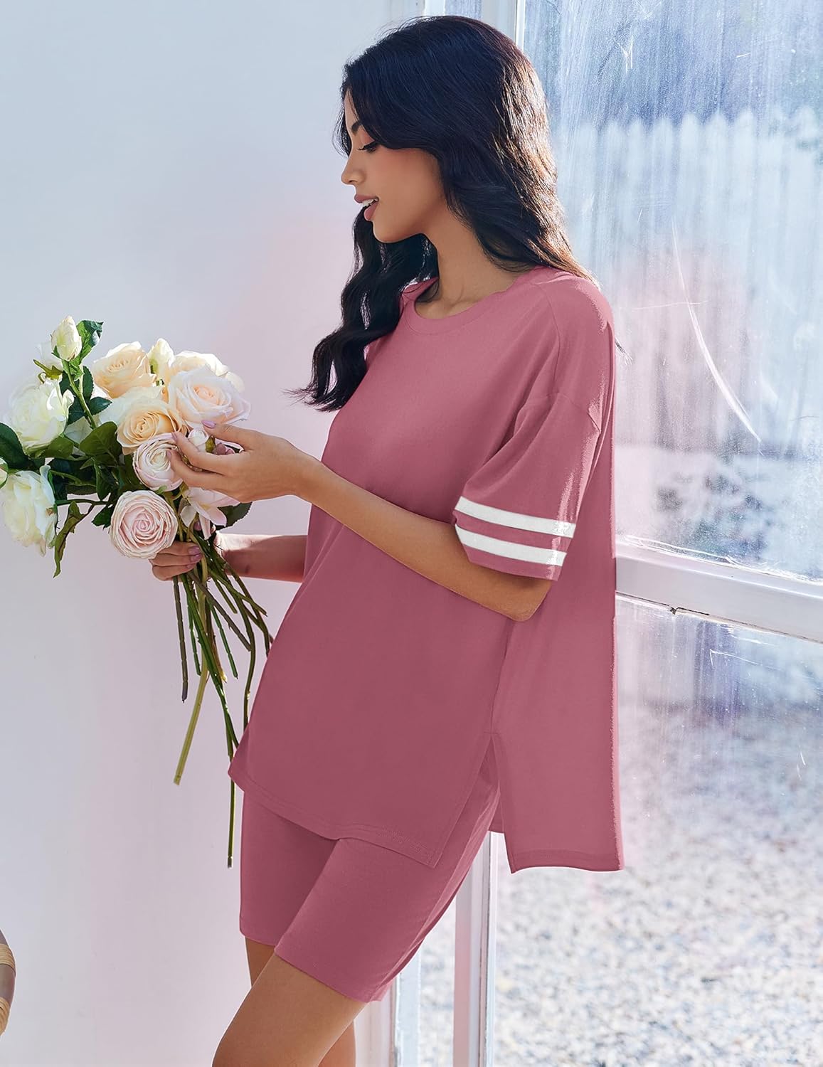 Two-piece lounge set in mauve pink with oversized tunic top and matching shorts, striped cuffs.
