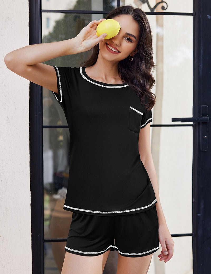 Black loungewear set with short-sleeve top and black shorts with white trim.