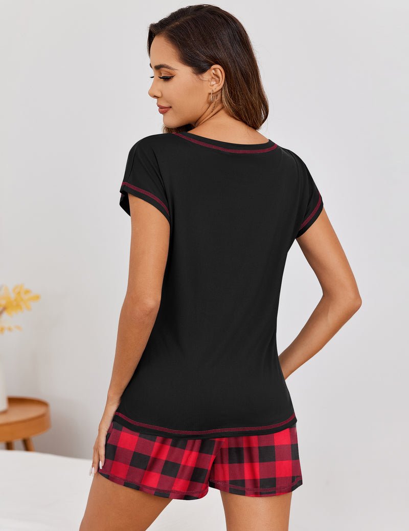 Black loungewear set with short-sleeve top and red plaid shorts, contrast trim.