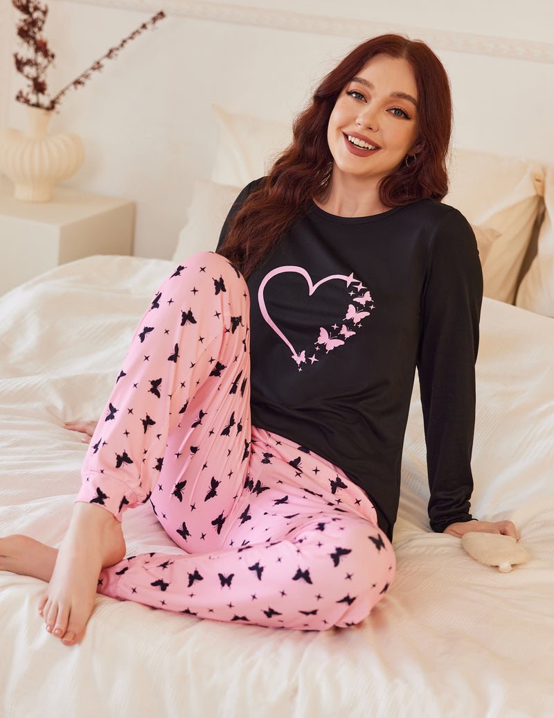 Pink patterned pajama pants with black long-sleeve top and pink heart graphic