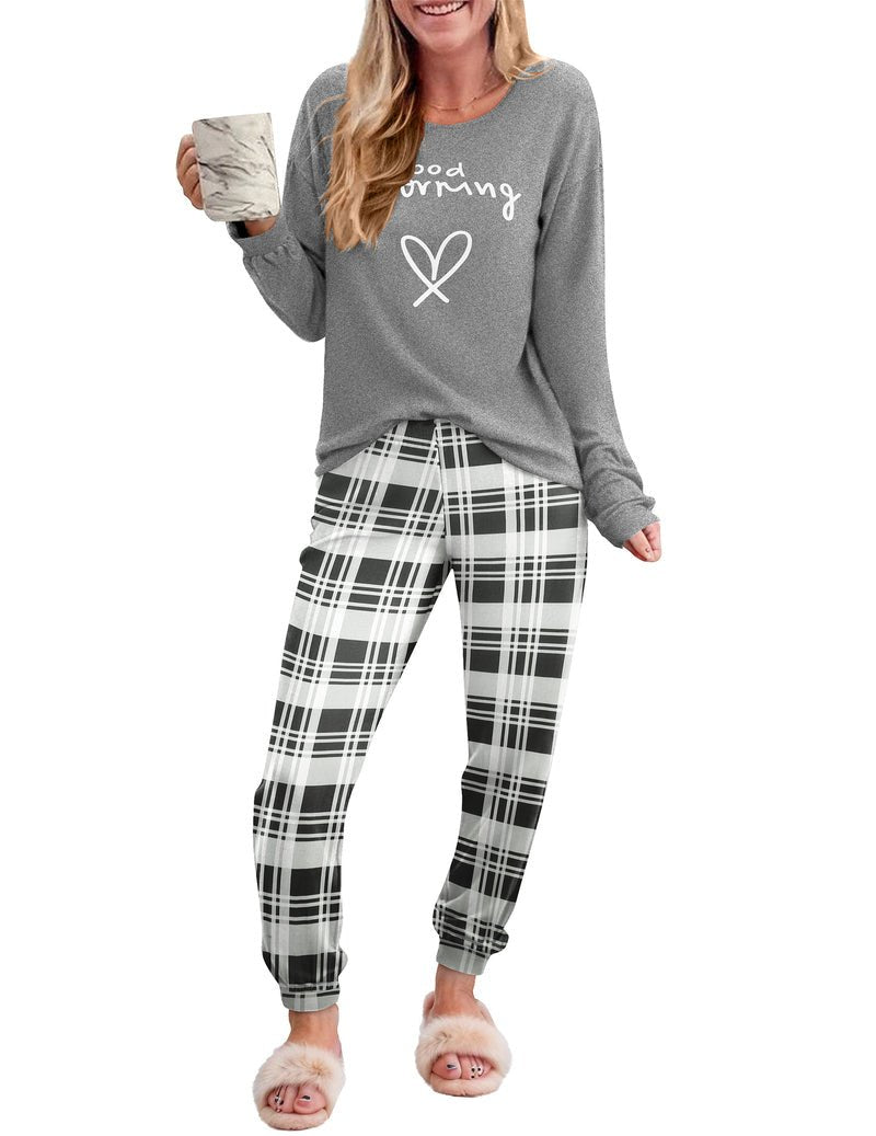 Gray long-sleeve pajama top with heart graphic and black-and-white plaid jogger pants