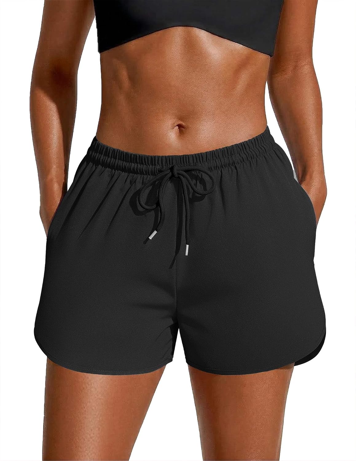 Black swim board shorts with elastic waistband and black drawstring tie