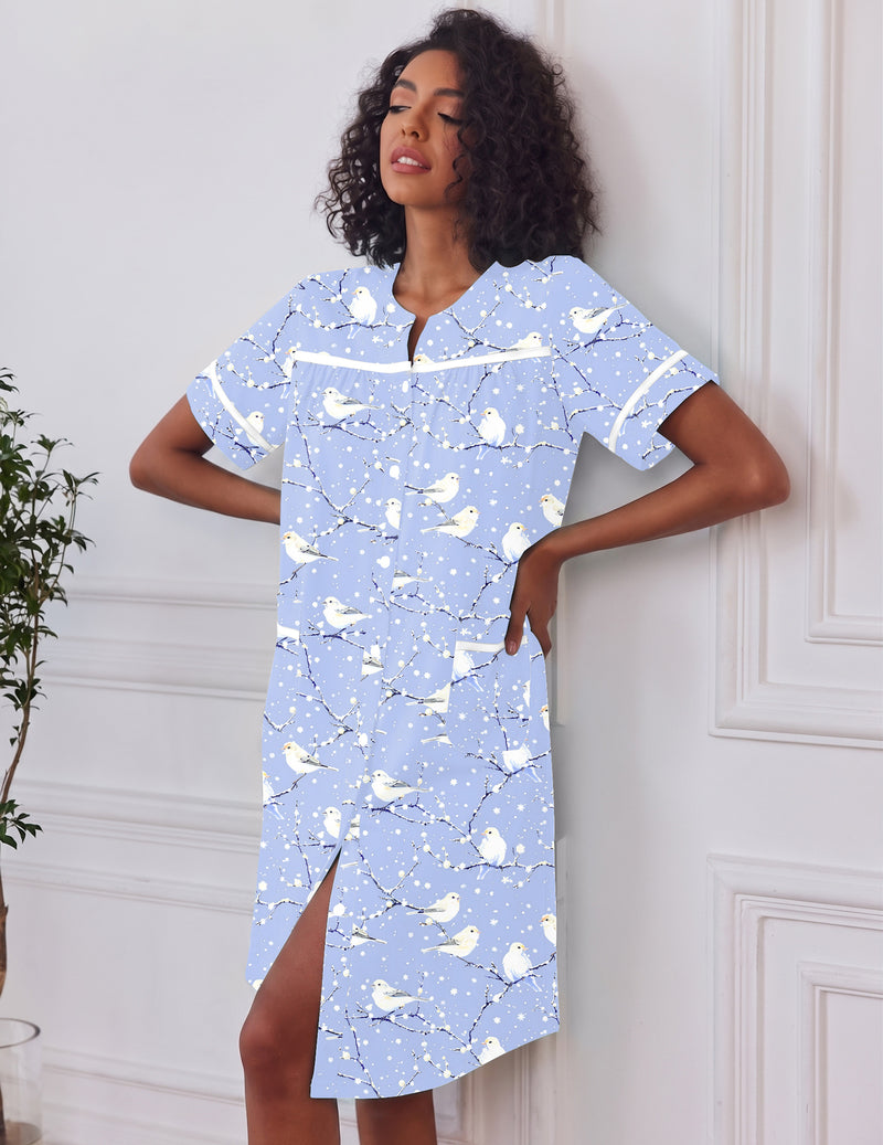 Light blue button-down house dress with short sleeves, pockets, split hem, front buttons
