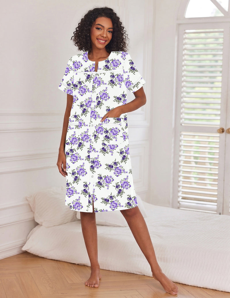 White button-down house dress with short sleeves and pockets, curved neckline, purple floral print