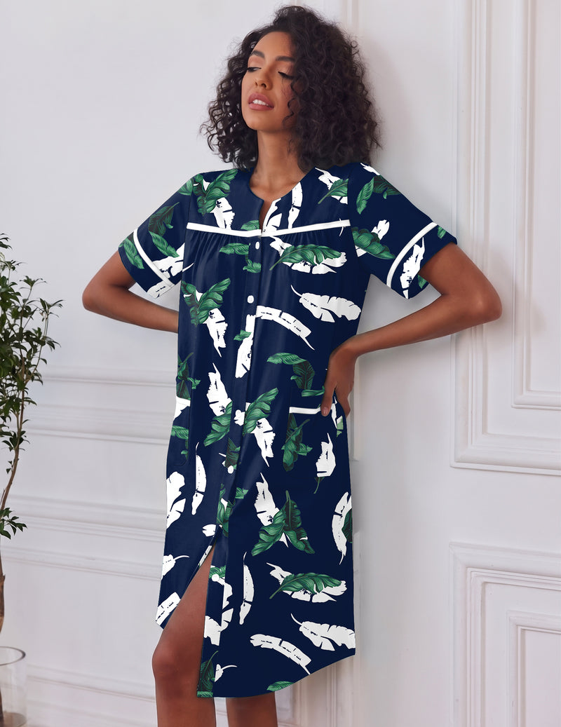 Navy button-down house dress with short sleeves, green leaf and white feather print