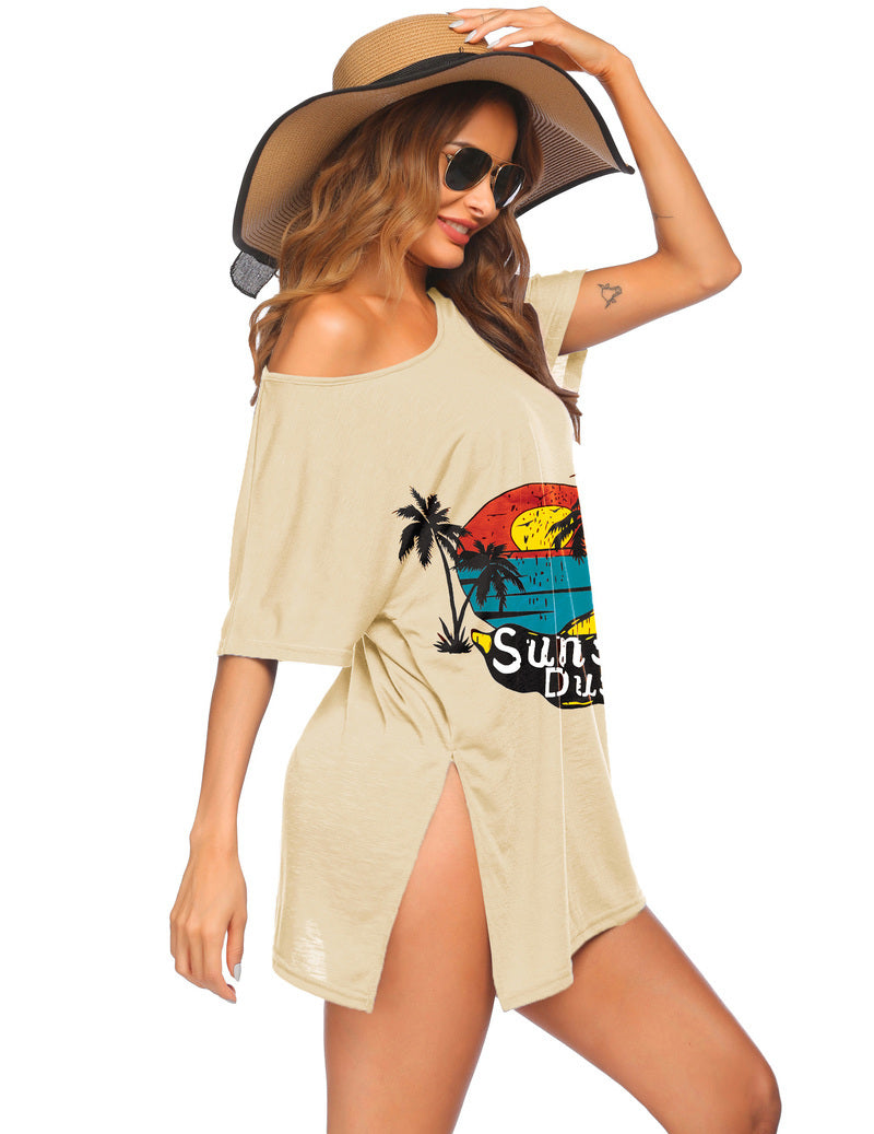 Beige short-sleeve swimsuit cover-up dress with off-shoulder neckline and tropical graphic print.
