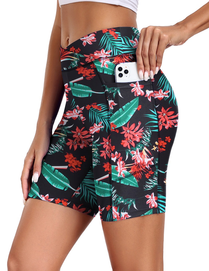 Black high-waist board shorts with tropical floral print and side pockets