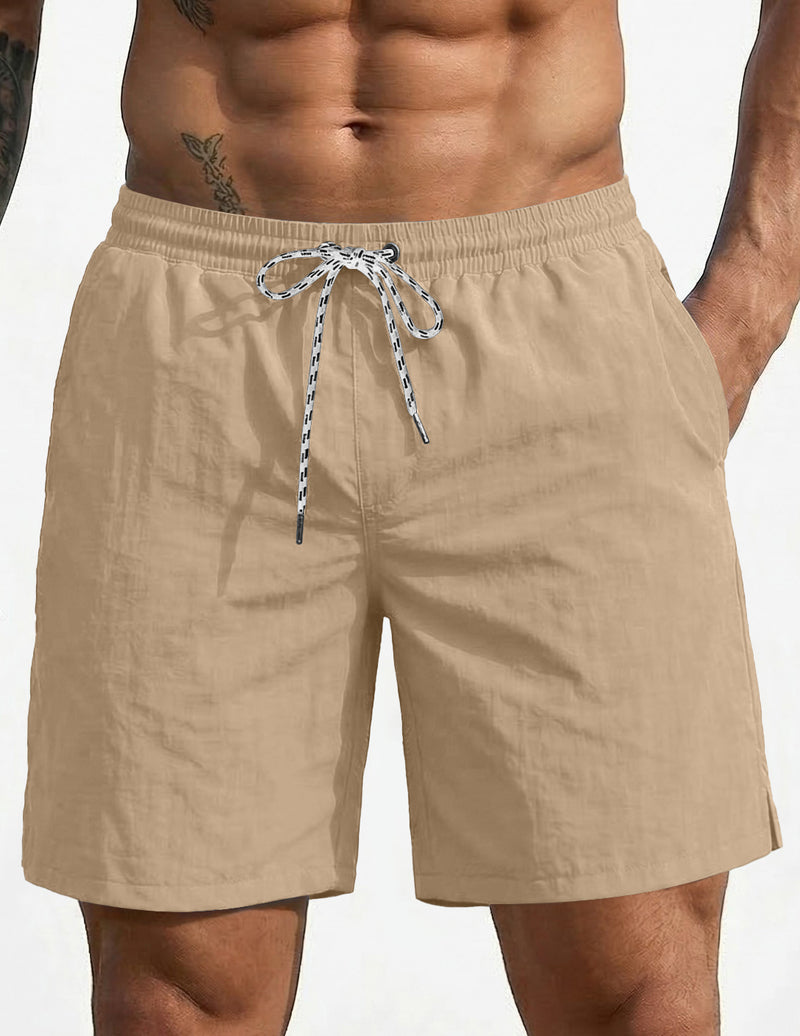 Tan swim board shorts with elastic waistband and drawstring, 7-inch length