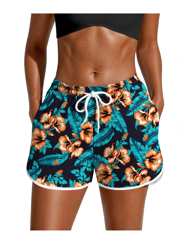 Teal floral swim board shorts with white drawstring and elastic waist