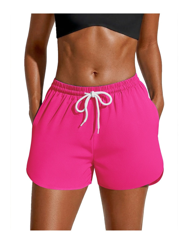 Pink swim board shorts with white drawstring waist