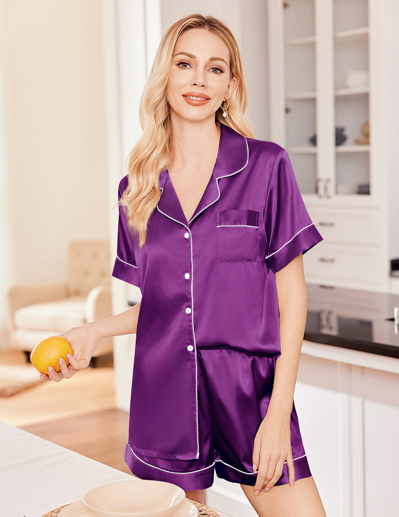 Purple satin pajama set with short-sleeve button-up top and matching shorts