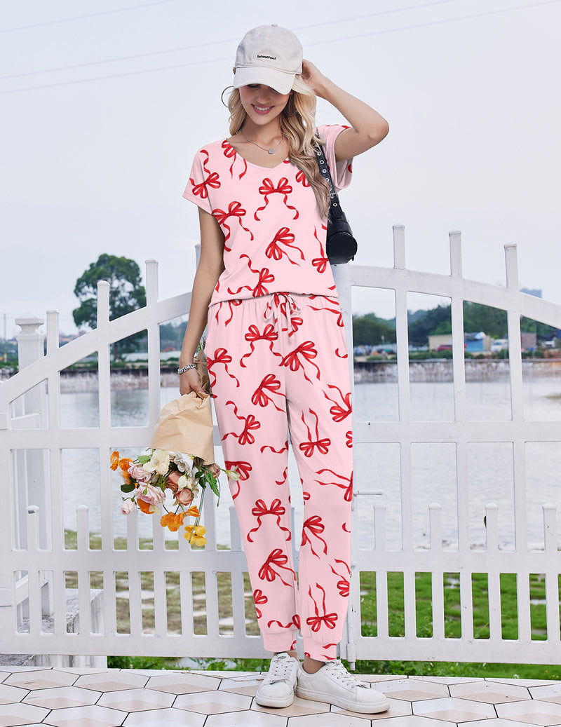 Pink short sleeve pajama set with drawstring jogger pants and red bow pattern