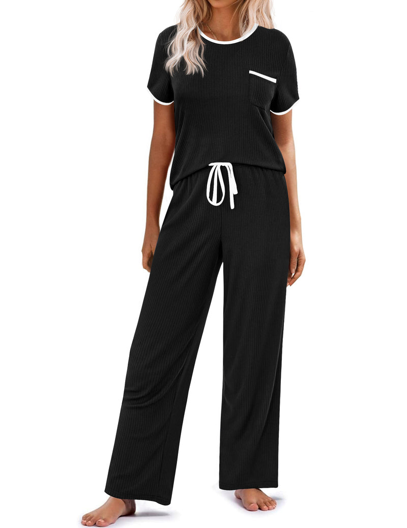 Ribbed knit pajama set in black: short-sleeve top with pocket, drawstring long pants.
