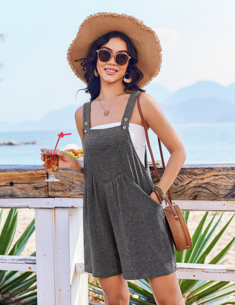 Sleeveless short overalls romper in charcoal gray with buttoned bib and two front pockets