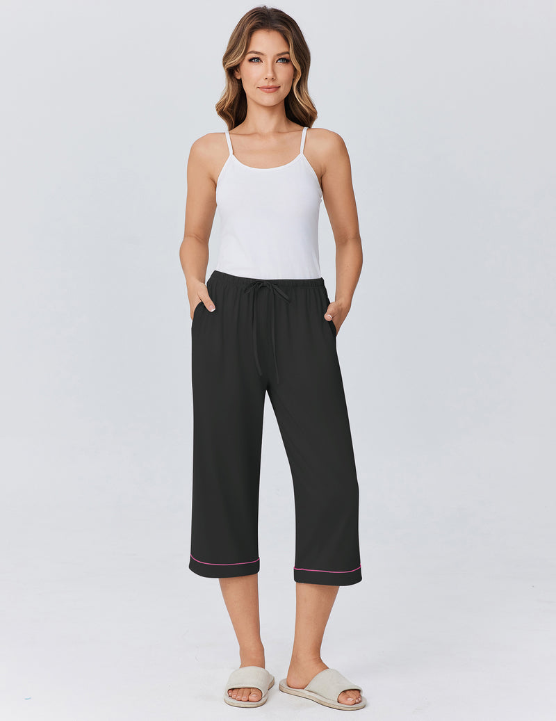 Black capri pajama pants with drawstring waist and red-trimmed hem