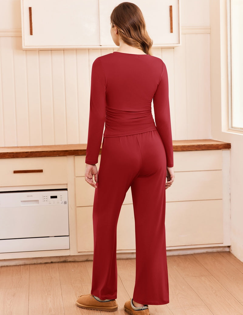 Back view of ruched long-sleeve top and wide-leg pants set in dark red/burgundy.