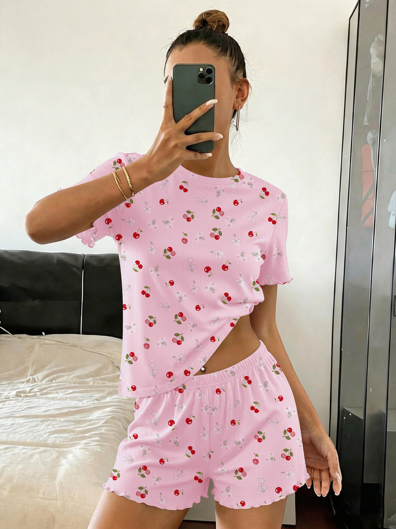Ribbed crop top and shorts pajama set in light pink with small red fruit floral print, elastic waist