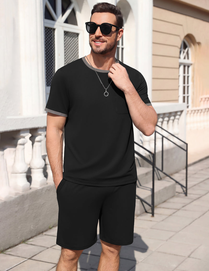 Men's short-sleeve pajama set, black top and matching shorts, standing front.