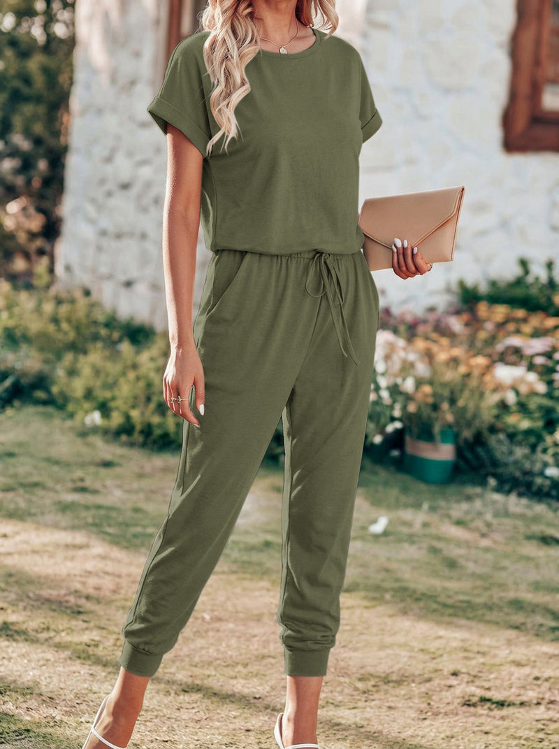 Olive green drawstring jumpsuit with short sleeves, elastic waist, and tapered cropped pants