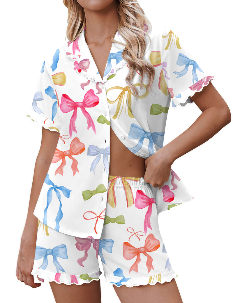 White pajama set with colorful bow print, button-down short sleeves, and matching shorts