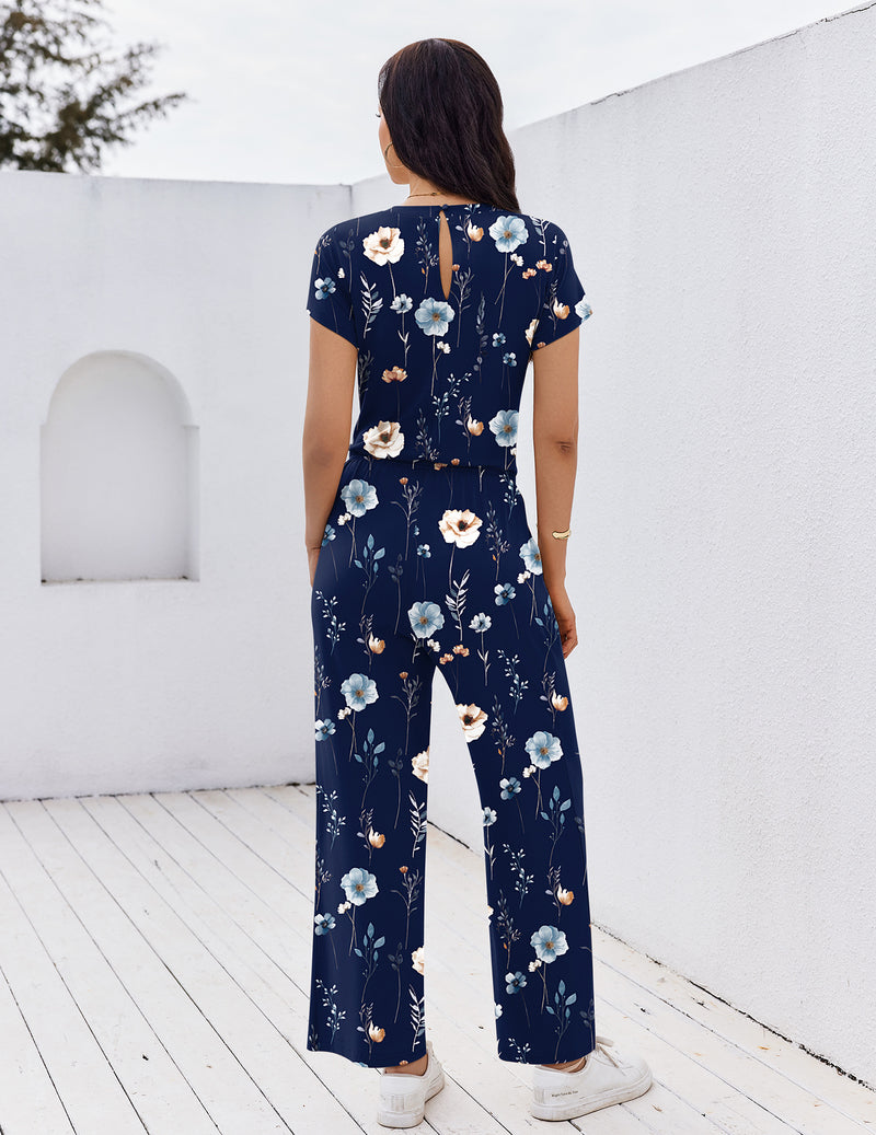 Navy floral short-sleeve jumpsuit with open-back detail and wide-leg pants