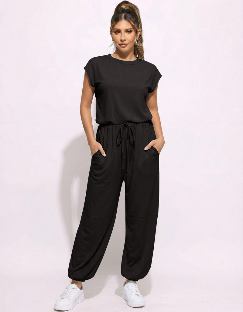 Black one-piece jogger jumpsuit with drawstring waist and relaxed tapered legs