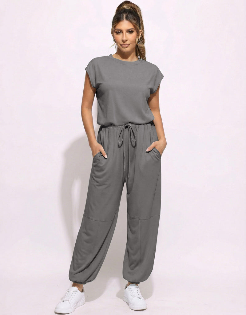 Gray one-piece jogger jumpsuit with drawstring waist and loose tapered pants