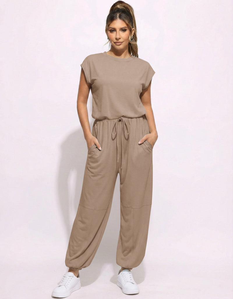 Taupe one-piece jogger jumpsuit with drawstring waist and relaxed tapered legs