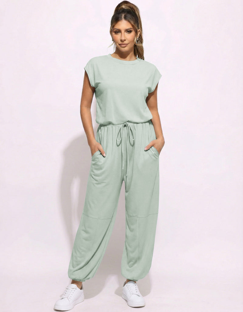 Mint green one-piece jogger jumpsuit with drawstring waist and tapered pant legs