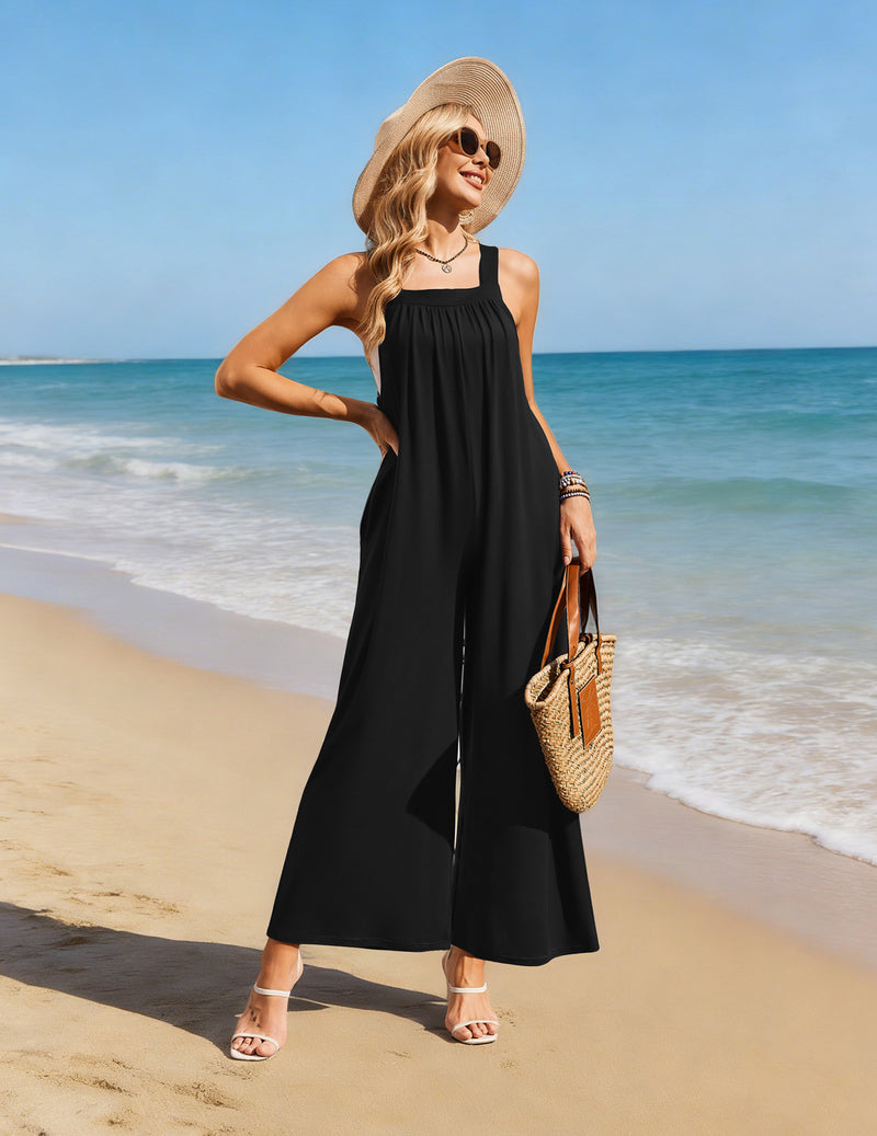 Black wide-leg jumpsuit overalls with adjustable straps and pocketed, relaxed fit