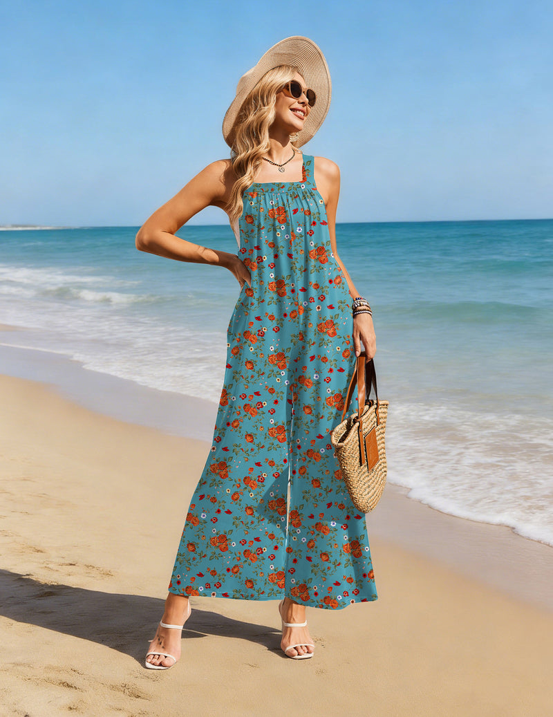 Teal floral wide-leg jumpsuit overalls with adjustable straps and relaxed, pocketed legs