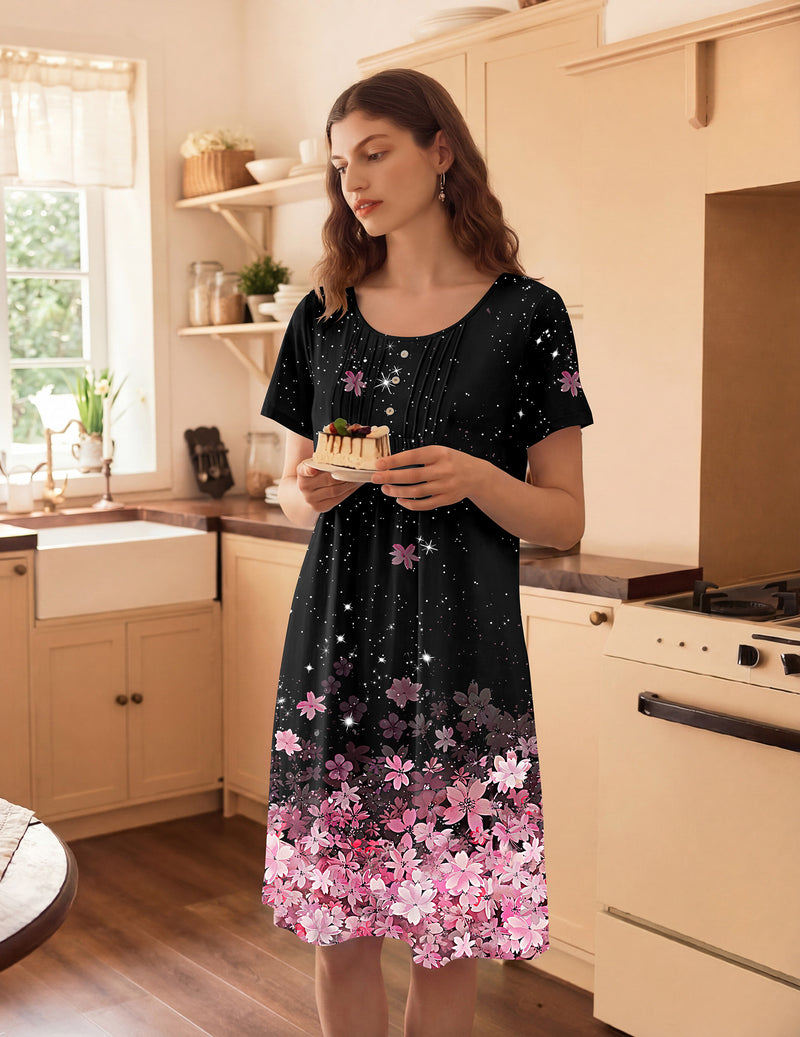 Short-sleeve mumu house dress in black with pink floral hem and small star-like accents