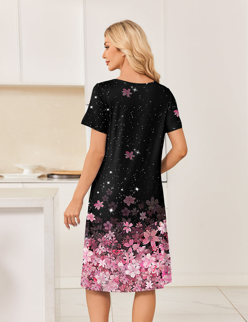 Back view of short-sleeve mumu dress in black with pink floral hem and speckled accents