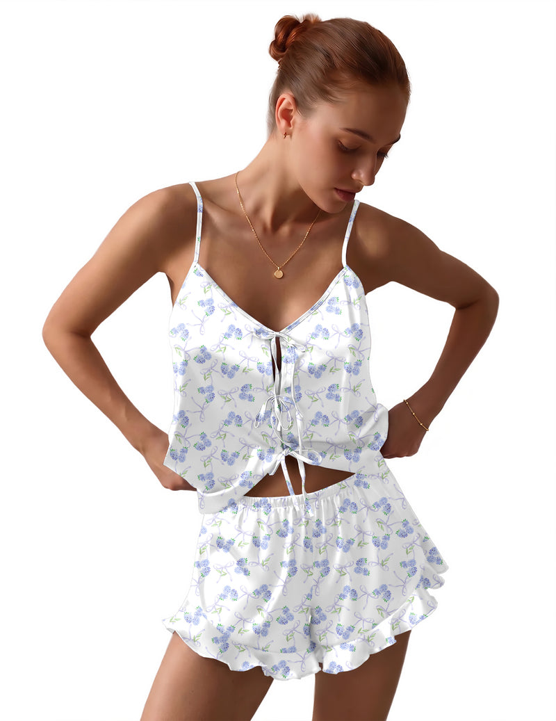 White satin pajama set with blue floral print, bow-tie front cami and ruffled shorts