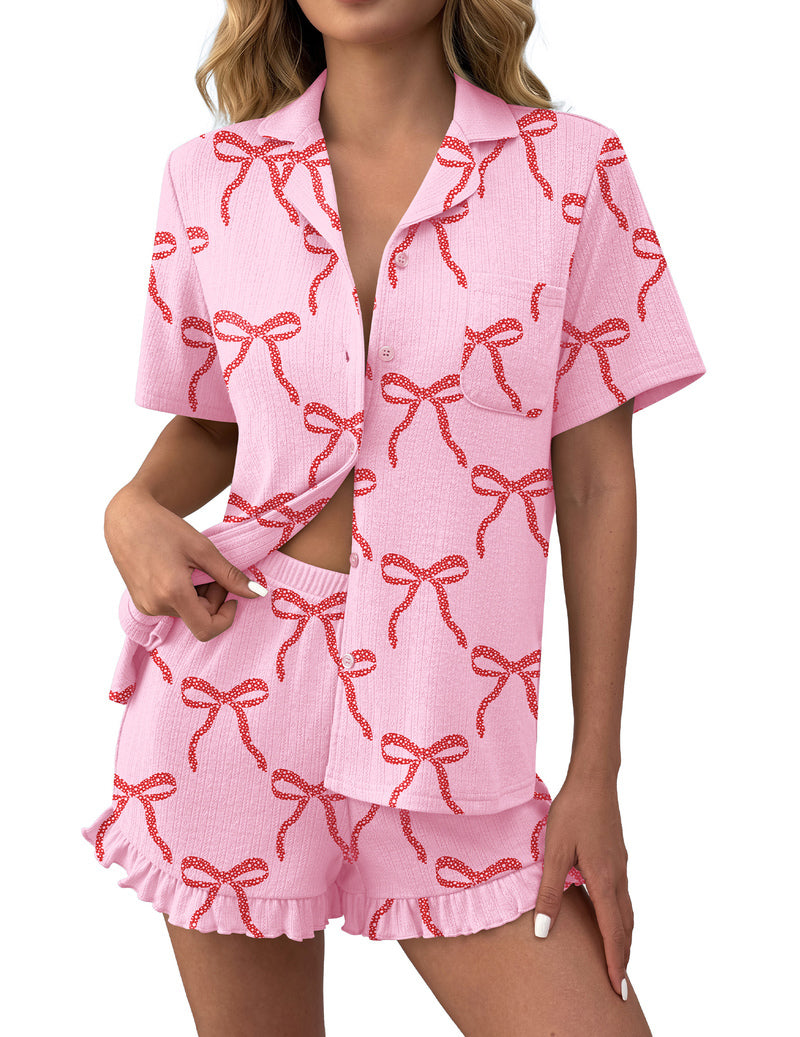 Pink bow pattern ruffled button-down pajama set with matching shorts, short sleeves.